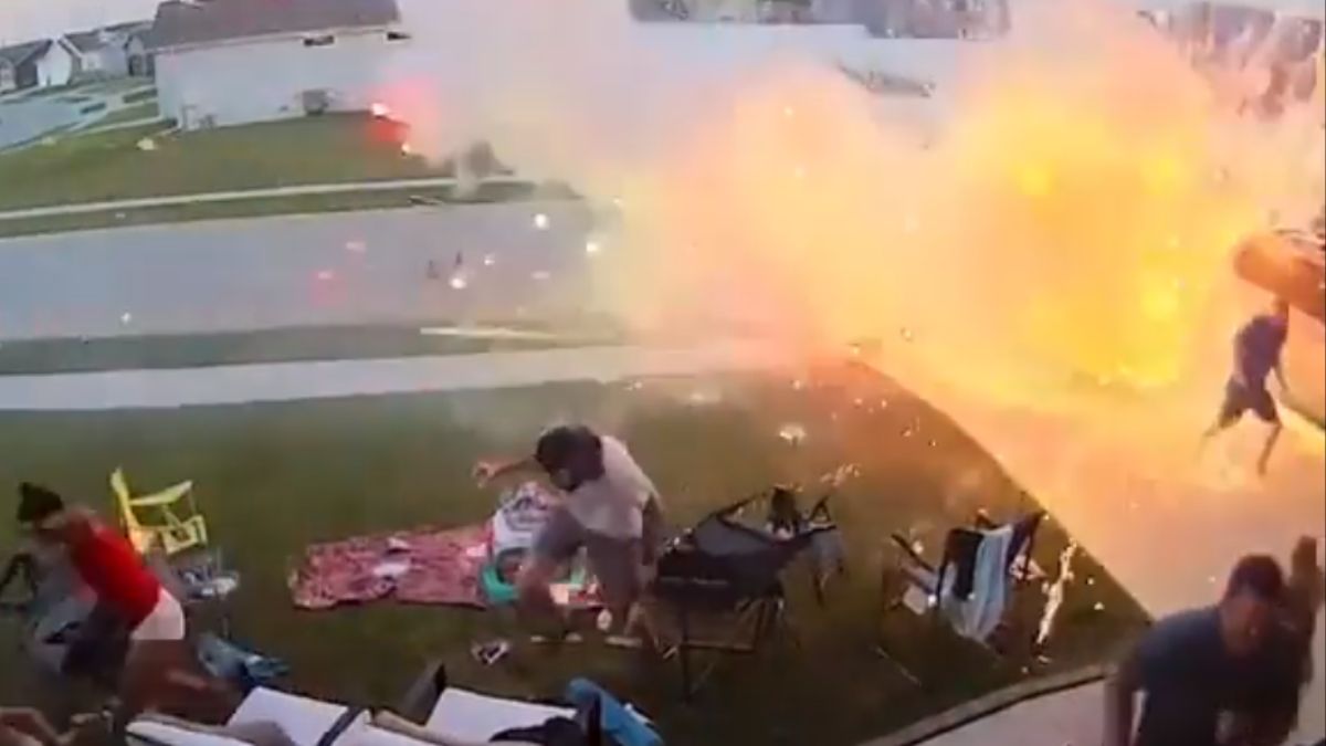 Family Flees Driveway During 'Out of Control' Fireworks Explosion - Watch Video