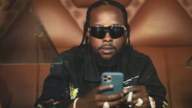 Popcaan on a phone